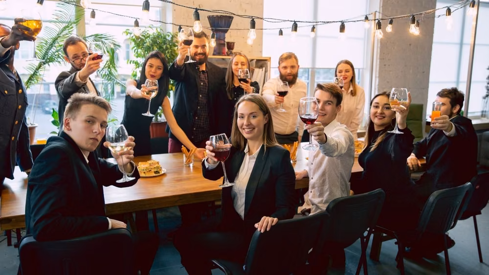 Colleagues raising a toast together at a corporate client appreciation event