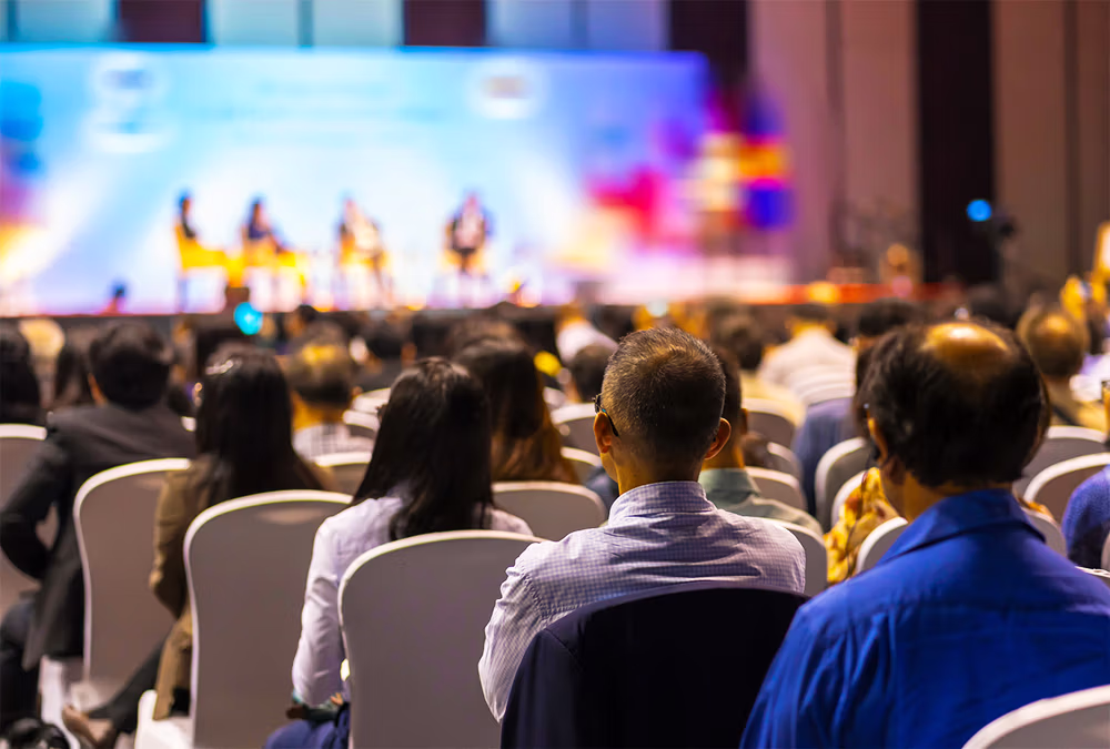 Audience seated at a large corporate conference