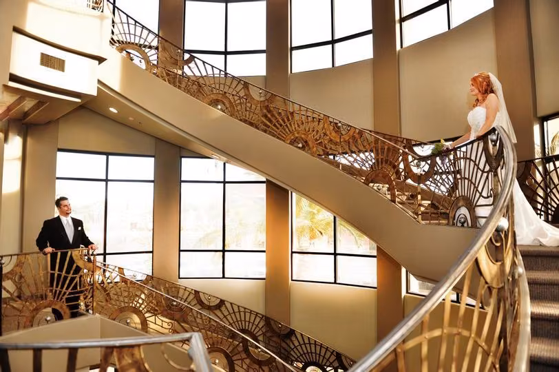 Bride and groom on the curved grand staircase at The Event Center at Whitney Ranch